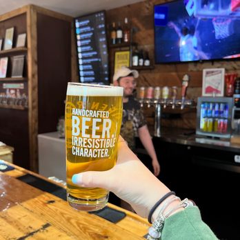 The 2nd Tap - a person holding a glass of beer - Beer Bar Near Me - Dallas, Texas The 2nd Tap - a person holding a glass of beer - Beer Bar Near Me - Dallas, Texas