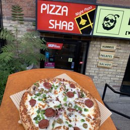 a pizza sitting on a table outside