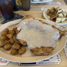 Chicken fried steak with fried okra and home fried potatoes.