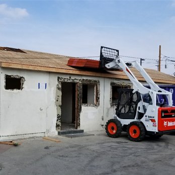 MK Construction & Demolition - a man on a forklift in front of a building - General Contractors Near Me - Los Angeles, California MK Construction & Demolition - a man on a forklift in front of a building - General Contractors Near Me - Los Angeles, California