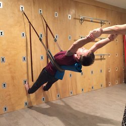 Raisha Love Yoga - Assisting with a backbend on The Great Yoga Wall.