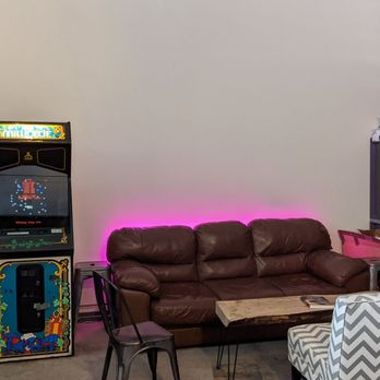The Void Sake - a living room with a couch, chair, and arcade machine - Distilleries Near Me - Lexington, Kentucky The Void Sake - a living room with a couch, chair, and arcade machine - Distilleries Near Me - Lexington, Kentucky