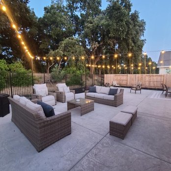 Larcom’s Event Lighting  - Permanent DW pattern string lights attached to cable wire with 2 steel pole posts cemented to the ground. - Holiday Decorating Services Near Me - Elk Grove , California