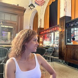 a woman sitting at a table in a restaurant a woman sitting at a table in a restaurant