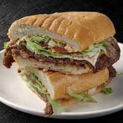 Fuego Cravings - A crispy breaded steak, beans, panela cheese, tomato, lettuce, onion, avocado, and our homemade FC chipotle spread.