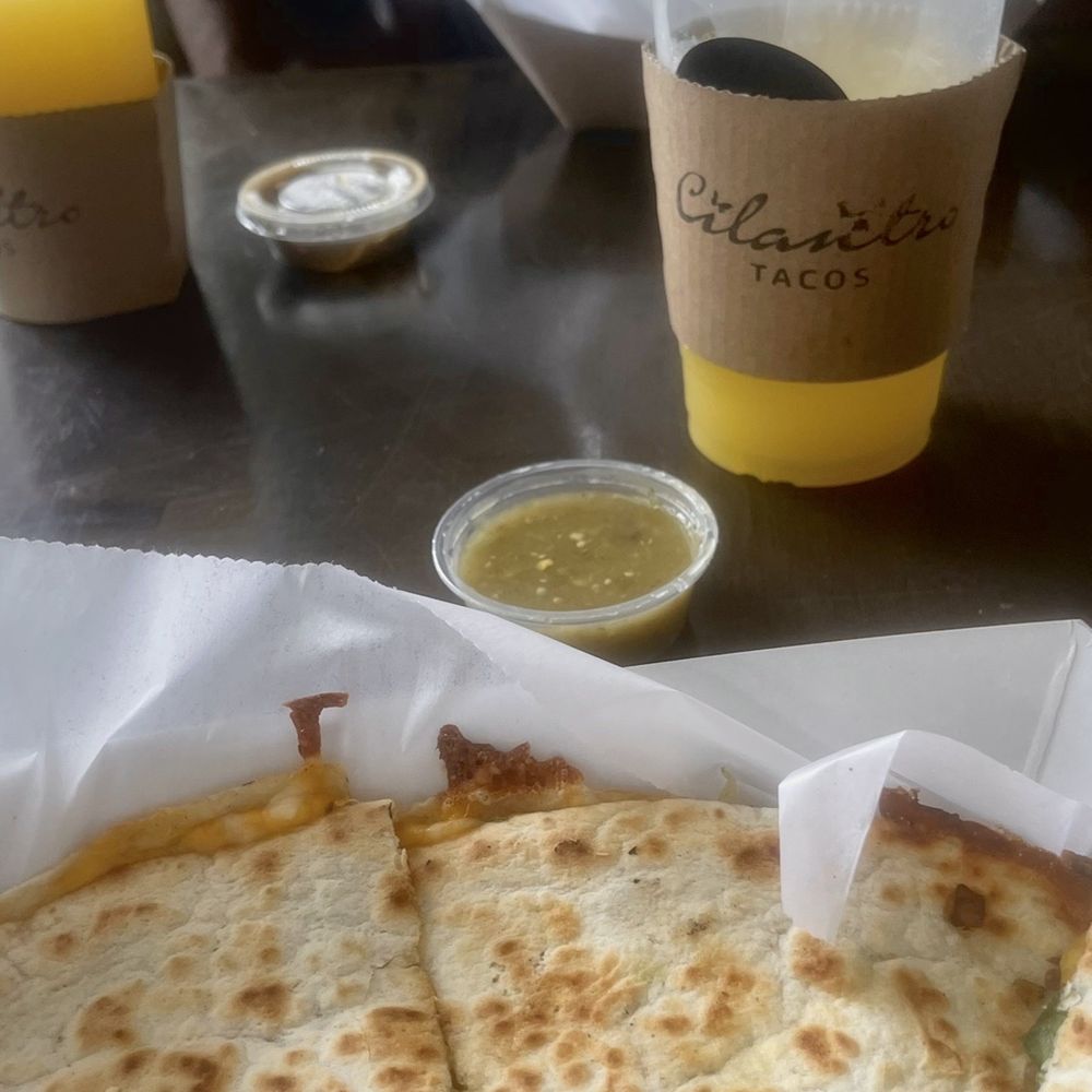 Cilantro Tacos - Rich and tasteful barbacoa quesadilla, fully loaded with verde and sour cream. - Tacos Near Me - Newberry, Florida Cilantro Tacos - Rich and tasteful barbacoa quesadilla, fully loaded with verde and sour cream. - Tacos Near Me - Newberry, Florida