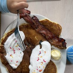 Kids pancakes (added whipped cream and sprinkles) with bacon