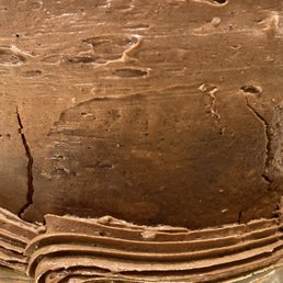 Visible large cracks on the side of the cake.