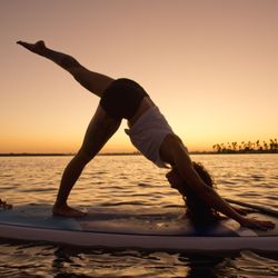 Sunset paddle board yoga classes on Mission Bay in San Diego.
