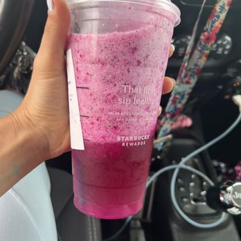 Starbucks - a hand holding a plastic cup with a drink in it - Coffee & Tea Near Me - Daytona Beach, Florida Starbucks - a hand holding a plastic cup with a drink in it - Coffee & Tea Near Me - Daytona Beach, Florida