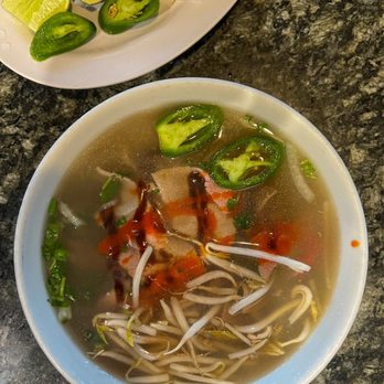 Pho 90 - a bowl of soup and a plate of vegetables - Vietnamese Near Me - Aurora, Colorado Pho 90 - a bowl of soup and a plate of vegetables - Vietnamese Near Me - Aurora, Colorado