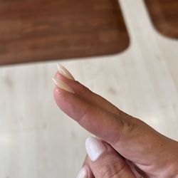 Top Service Nails - Due to so much glue on my middle nail the nail flares out compared to index nail that follows natural nail