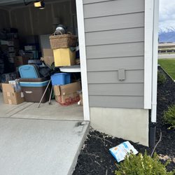 US Post Office - Delivery in the bushes near the garage. The front porch is on the other side of the house.