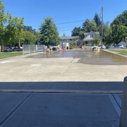 Splash pad, sensor activated. This photo is taken from under the shade awning, with 3 picnic tables.