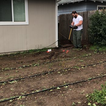 Elevate Lawn Care - Working on a customers backyard garden - Lawn Services Near Me Elevate Lawn Care - Working on a customers backyard garden - Lawn Services Near Me