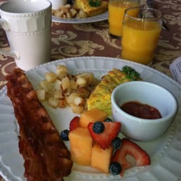 Chili cheese puff with fruit, bacon, potatoes, OJ and coffee