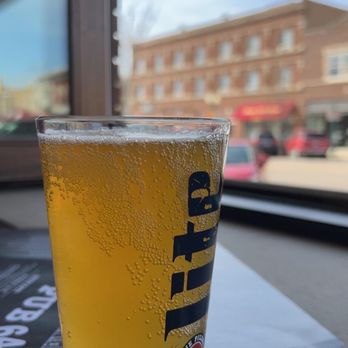Pub 64 - a glass of beer on a table - New American Near Me - Sycamore, Illinois
