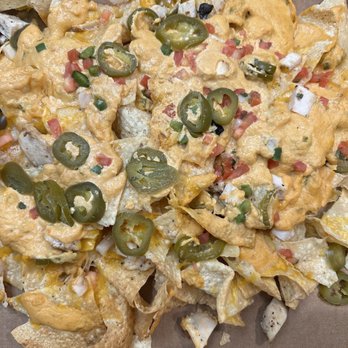 BJ's Restaurant & Brewhouse - Nachos with chicken, globs of gross cheese and little else. - New American Near Me - Laurel, Maryland