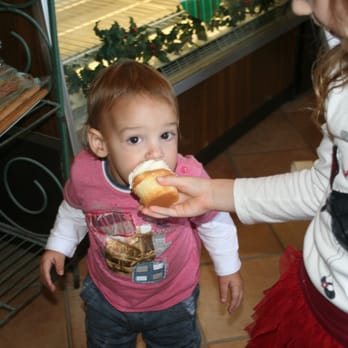 Italia Bakery - a toddler eating a hot dog - Bakeries Near Me - Dearborn, Michigan