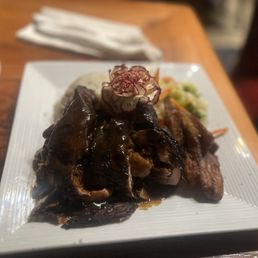 Jerk chicken with mashed Yam and sautéed vegetables and fried plantains