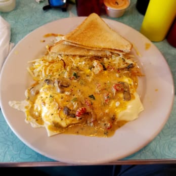 Dots Diner - Williams Blvd. - Biscuits smothered and covered with eggs layered with Swiss cheese and drizzled with a Crawfish Creole sauce, Side of hash brown and toast. - Diners Near Me - Kenner, Louisiana