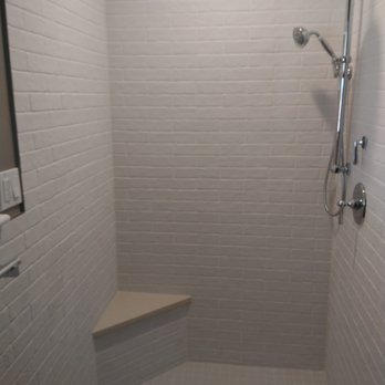 STS Renovation - a shower with a bench in the corner - General Contractors Near Me