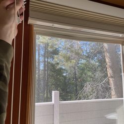 Rendezvous Mountain Rentals - Broken blinds by a door facing a bed