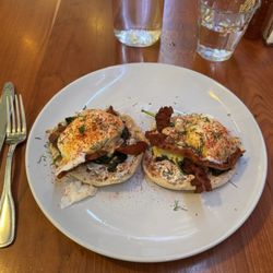 Morning Social - Eggs Benny with bacon and spinach. Paired with blood red orange juice. Delicious