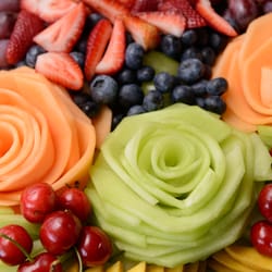 Fruit Platters And More - We can customize your platters with melon roses or edible orchids or both! Have an allergy, let us know and we will leave that fruit off.