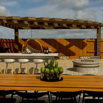 The Yard Company - a patio with a table and chairs - Landscaping Near Me The Yard Company - a patio with a table and chairs - Landscaping Near Me