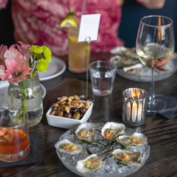 The Leavitt Theatre - a table with oysters and drinks - Cocktail Bars Near Me - Ogunquit, Maine