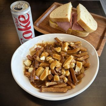 Lester's Deli - Classic Poutine fries and Montreal Classic (but subbed out rye bread for sourdough). Side of coleslaw not shown. - Delis Near Me - Henderson, Nevada