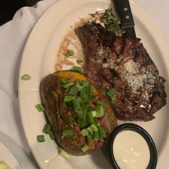 Lucia's Steakhouse - Steak and loaded baked potato! Comes with a salad as well. My sister got this medium well and she absolutely loved it! - Steakhouses Near Me - Canton, Ohio