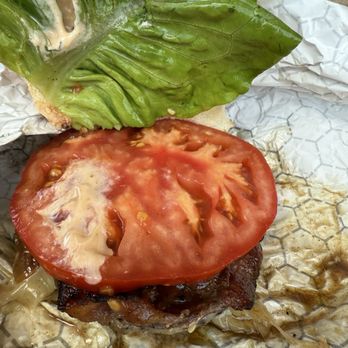 Lucky Hare Brewing - See the beautiful tomato, compliments their burger perfectly, and love that it covers the whole smash burger. That's a big, juicy slice - Brewpubs Near Me - Hector, New York