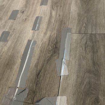 JCI Flooring - floors cracked and buckling - taped down - Flooring Near Me JCI Flooring - floors cracked and buckling - taped down - Flooring Near Me