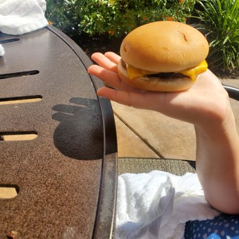 Barefoot Pool Bar - a person holding a hamburger - Bars Near Me - Bay Lake, Florida Barefoot Pool Bar - a person holding a hamburger - Bars Near Me - Bay Lake, Florida