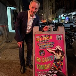 DJ TM.8 - '80s club regular, GenX Andy stands by the Street Sign, dated August 23, 2025.