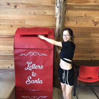Inez Kitchen - a woman standing next to a letter to santa mailbox - New American Near Me - Havana, Florida Inez Kitchen - a woman standing next to a letter to santa mailbox - New American Near Me - Havana, Florida