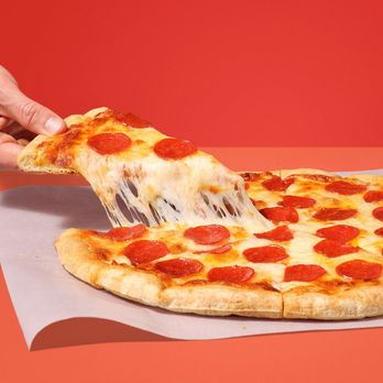 Circle K - a slice of pepperoni pizza being held by a person - Convenience Stores Near Me - St. Augustine, Florida