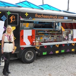 a woman standing in front of a food truck