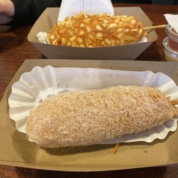In the foreground Panko fried (coated in sugar)with 1/2 cheddar and 1/2 hot dog and a French fry crust with 1/2 cheddar and 1/2 hotdog