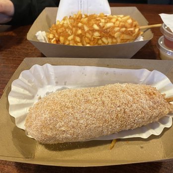 Seoul Stix Korean Corndogs  - In the foreground Panko fried (coated in sugar)with 1/2 cheddar and 1/2 hot dog and a French fry crust with 1/2 cheddar and 1/2 hotdog - Korean Near Me - Phoenix, Oregon