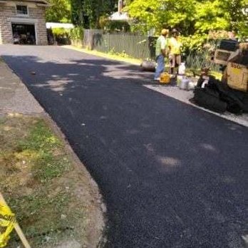 Delite Paving - a man working on a driveway - General Contractors Near Me Delite Paving - a man working on a driveway - General Contractors Near Me