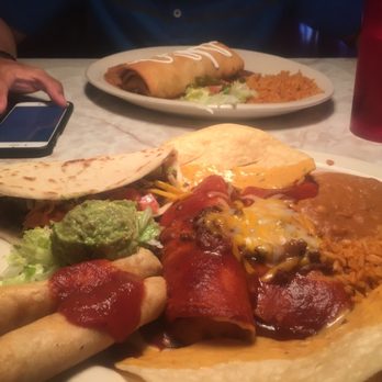 Chuy's - The Combination platter up front and in the back is their version of the Chimichanga (I think it's called a Chuychanga) - Tex-Mex Near Me - Raleigh, North Carolina Chuy's - The Combination platter up front and in the back is their version of the Chimichanga (I think it's called a Chuychanga) - Tex-Mex Near Me - Raleigh, North Carolina