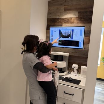 Villa Park Pediatric Dentistry - Dr Grace showing our daughter her X-rays - Pediatric Dentists Near Me - Villa Park, California Villa Park Pediatric Dentistry - Dr Grace showing our daughter her X-rays - Pediatric Dentists Near Me - Villa Park, California