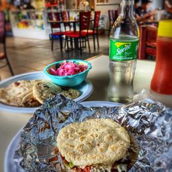 Sabor Catracho Latin Cuisine - Interior of the shop. A Burrita Hondureños, some papusas, and a Sprite.