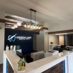 Crystal Lake Dental Arts - The front desk and lobby are gorgeous, modern wood accents, warm lighting, and a super welcoming vibe the moment you walk in.