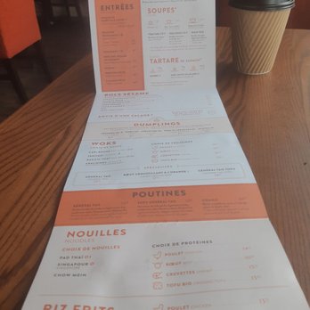 Sésame - a menu and a cup of coffee on a table - Asian Fusion Near Me - Boucherville, Quebec