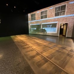 Greenwood Rising - The railroad tracks with a moving display on the shop behind it. Immersion was amazing
