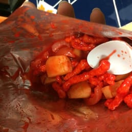 Tostiloco with hot cheetos, chamoy (chili), cucumber, cuerito, and mango! Tostiloco with hot cheetos, chamoy (chili), cucumber, cuerito, and mango!